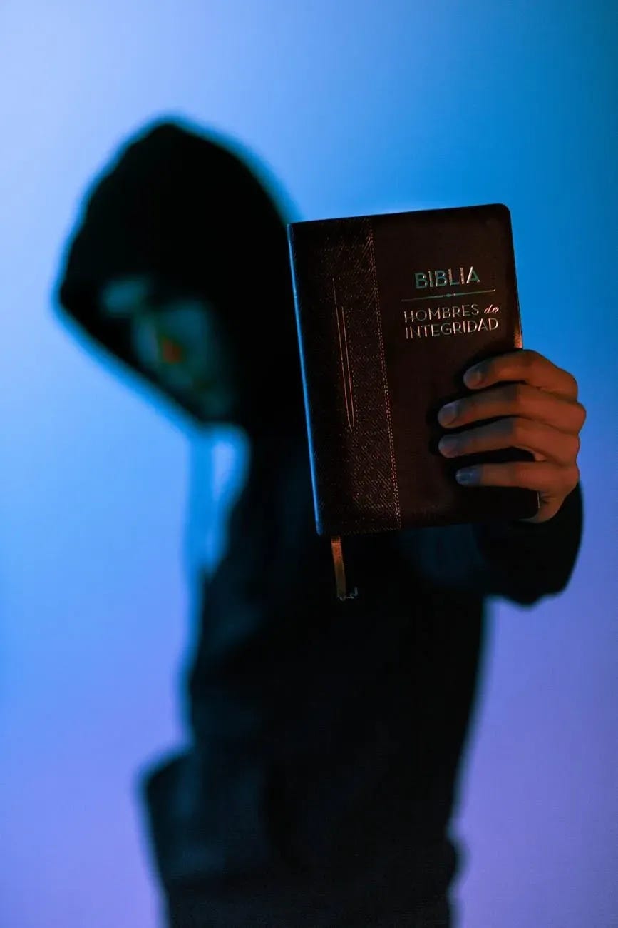 selective focus photography of man holding bible