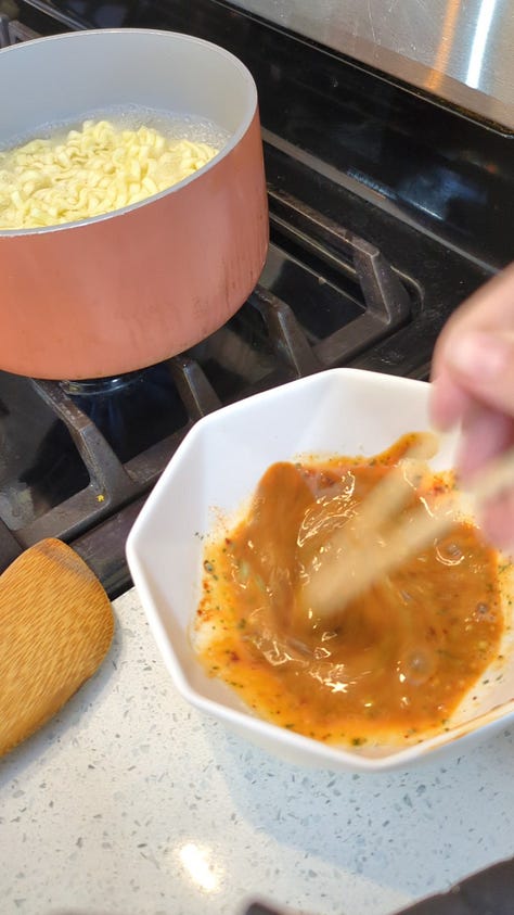 Buldak carbonara packet being opened, cooked, sauce packets mixed and finished noodles raised with chopsticks from the bowl.