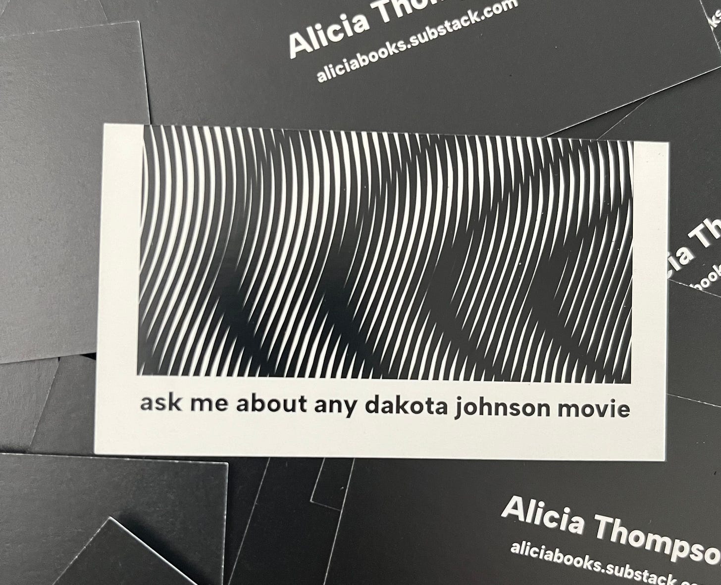 Photo of business cards that say "ask me about any dakota johnson movie" Photo of business cards that say "ask me about any dakota johnson movie"