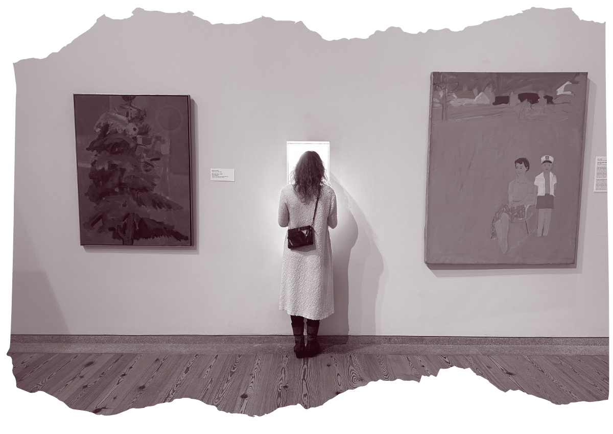 A black and white image of a woman from behind, observing paintings in an art gallery. She is wearing a white dress and is focused on a dark, abstract painting of a tree.
