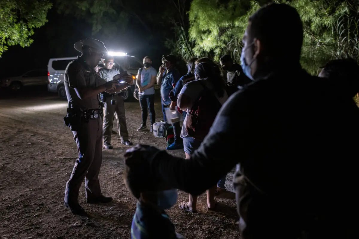 Illegal immigrants from Venezuela turn themselves in to Texas state troopers after crossing the border from Mexico into Del Rio, Texas, on May 18, 2021. (John Moore/Getty Images)