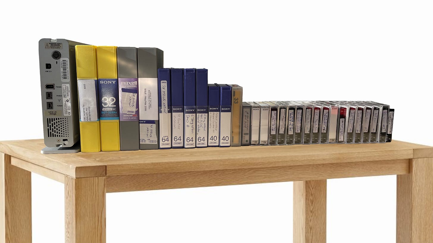 Photo of multiple DV cassettes in various formats plus a big fat FireWire hard drive