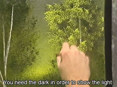 This may contain: someone is painting trees in the forest with their fingers and pointing them at each other