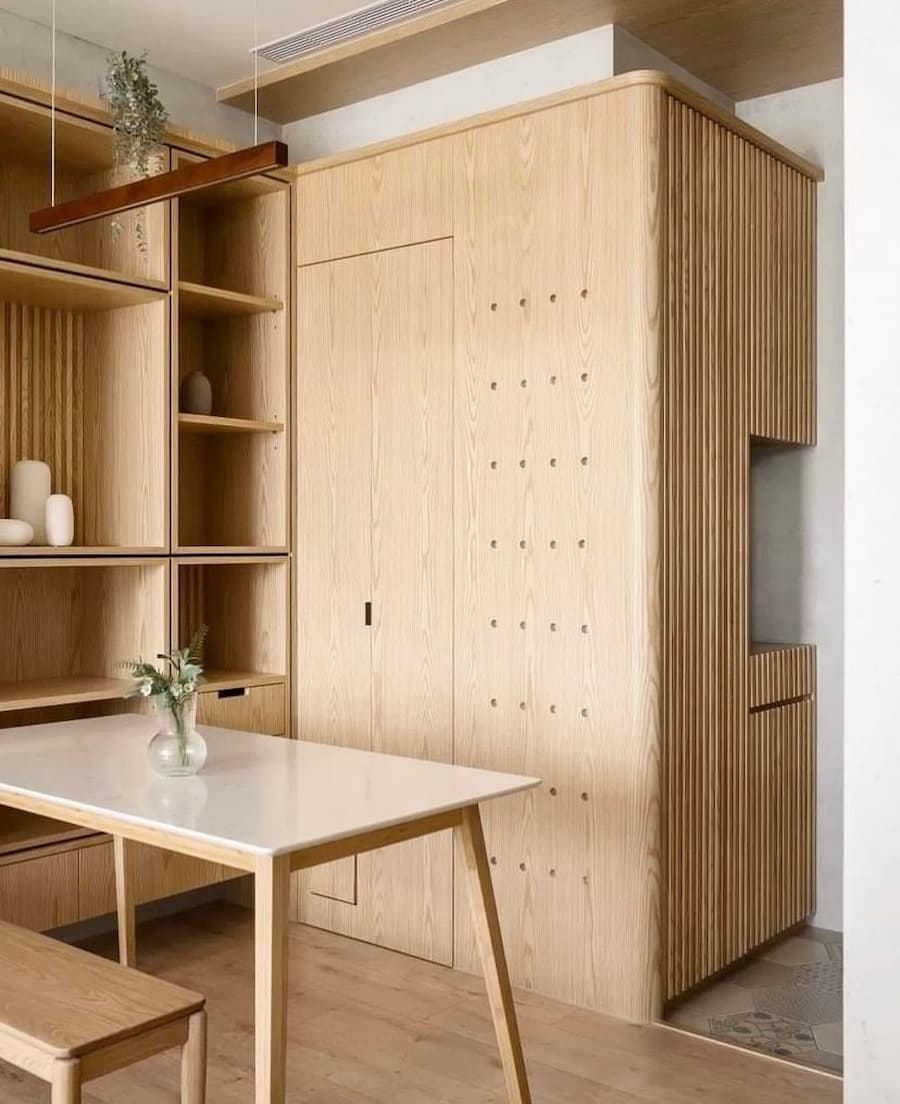 light wood kitchen units combined with cureved edge and fluted panelling details light wood kitchen units combined with cureved edge and fluted panelling details