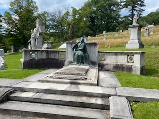 a picture of a real gravestone and statue in a cemetery a picture of a real gravestone and statue in a cemetery