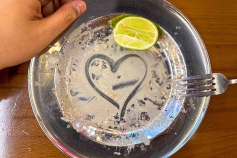 Al Naqa's Lao Tahini Caesar's Salad and the Special Hay Yai Dubai Fried Chicken Quarter Leg. A message to AJ, written by hand.