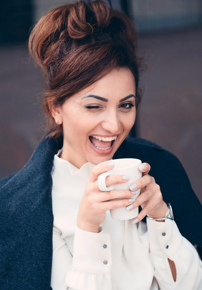 woman in white long sleeve shirt smiling