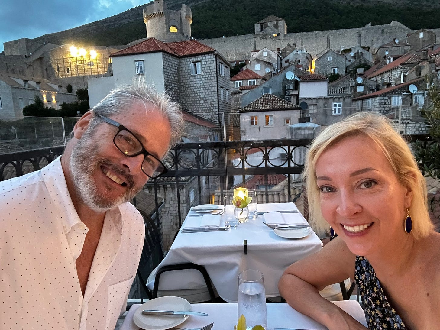Kelly and Nigel Benthall dining on a terrace overlooking Dubrovnik’s old town at sunset during their first stop on their gap year abroad.