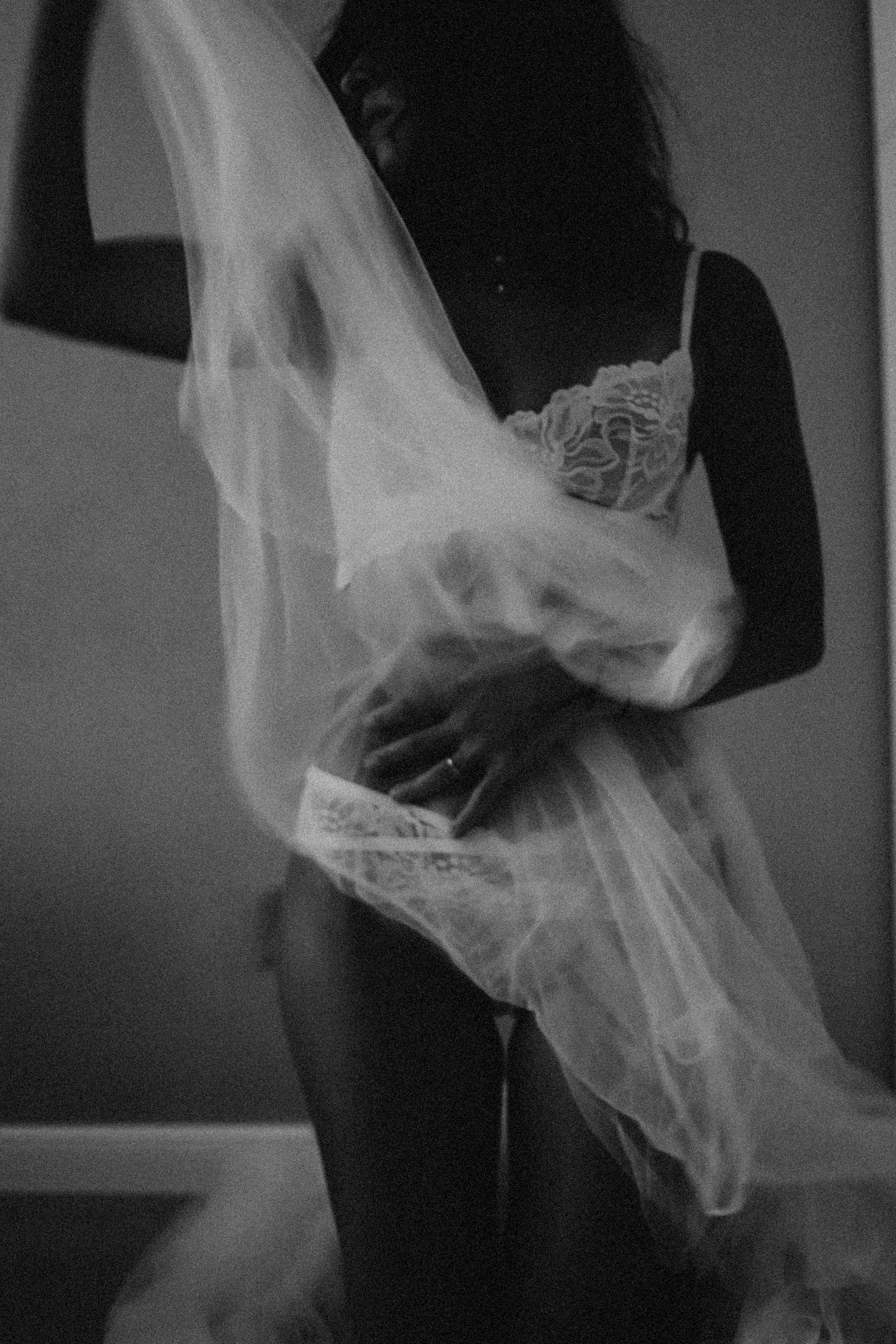 Woman with wispy fabric, wearing white bra and panties in black and white photo Woman with wispy fabric, wearing white bra and panties in black and white photo