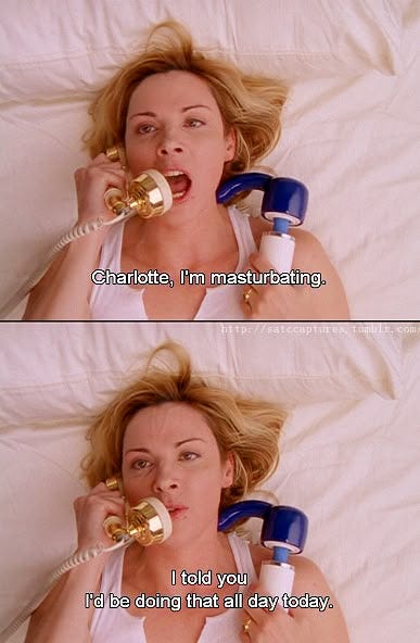 This may contain: a woman laying in bed talking on the phone and holding two phones to her ear