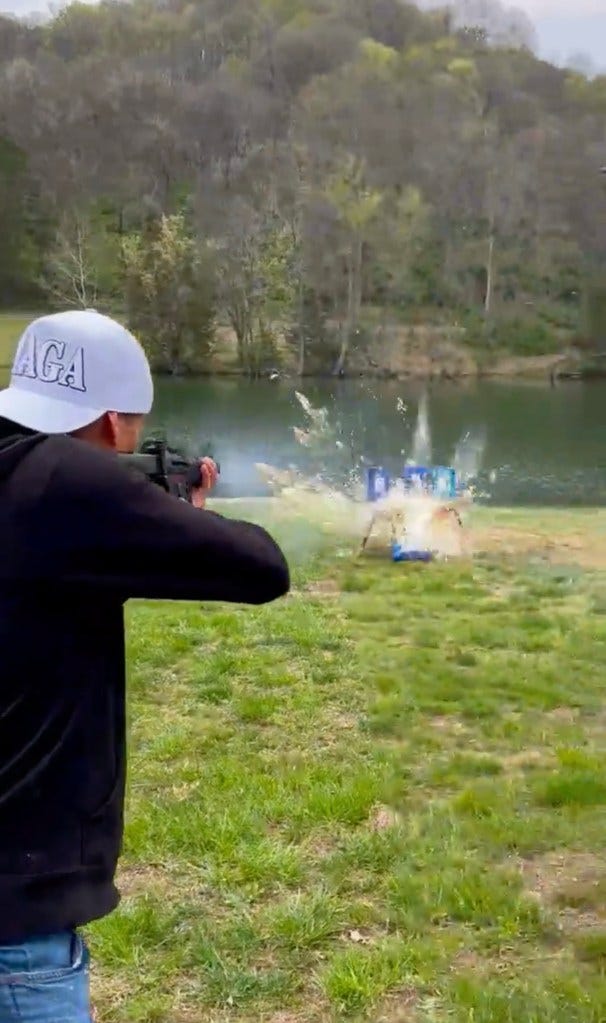 Kid Rock shooting the beer cans. Kid Rock shooting the beer cans.
