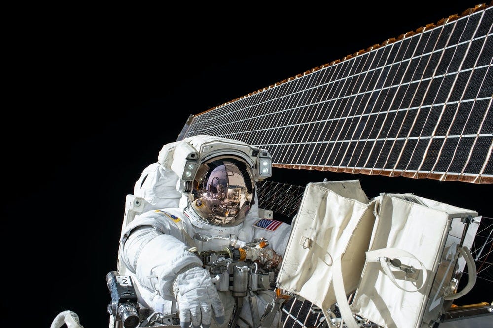photography of Astronaut beside satellite photography of Astronaut beside satellite