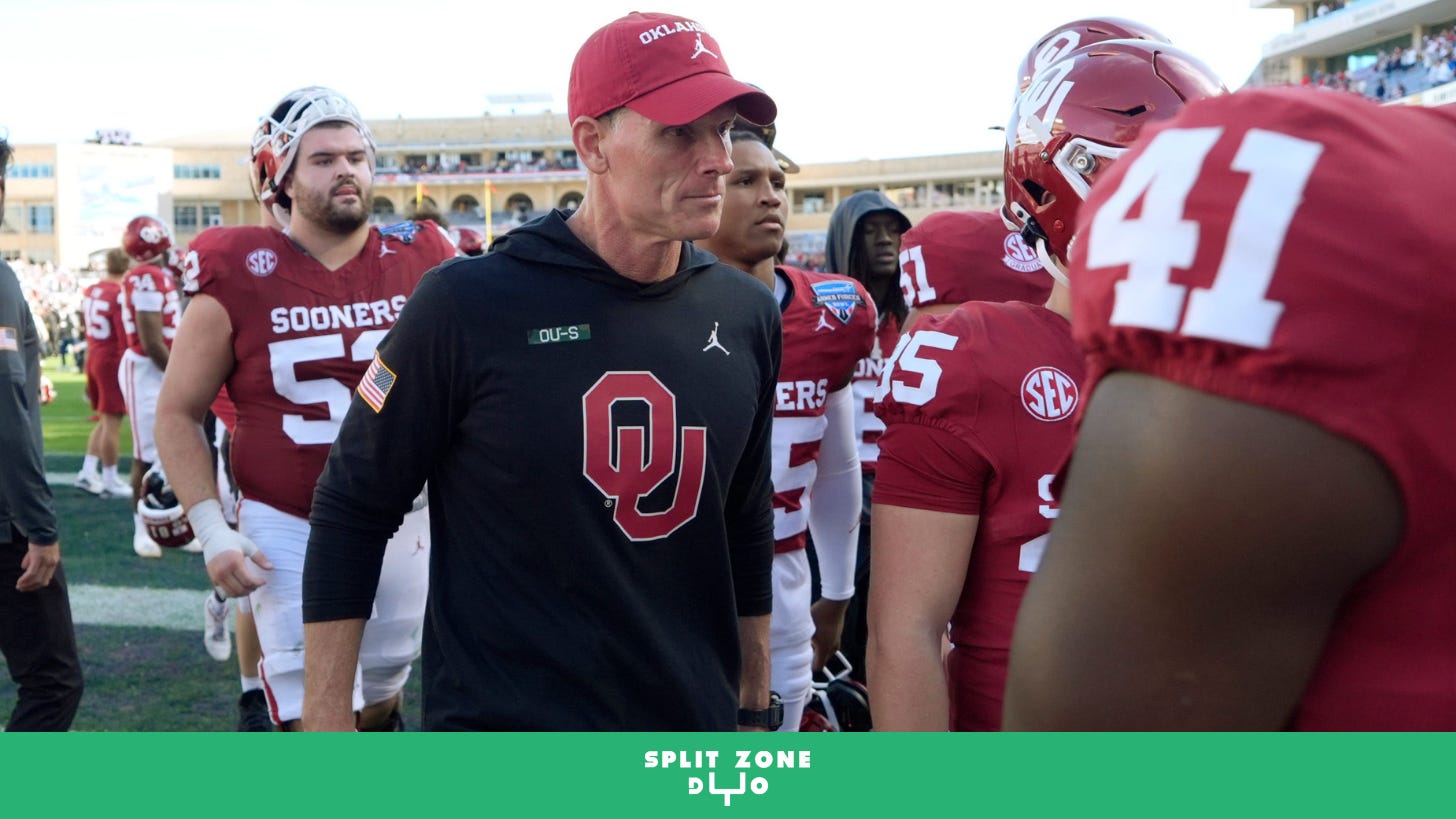 Brent Venables walks off the field with Oklahoma players