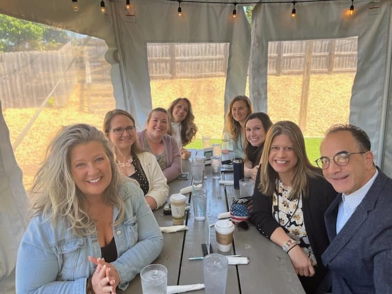 May be an image of 6 people, people smiling and table