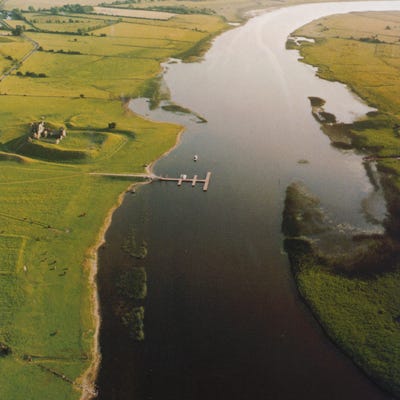 A broad river with fields either side, and an earthwork to one side of it. A broad river with fields either side, and an earthwork to one side of it.