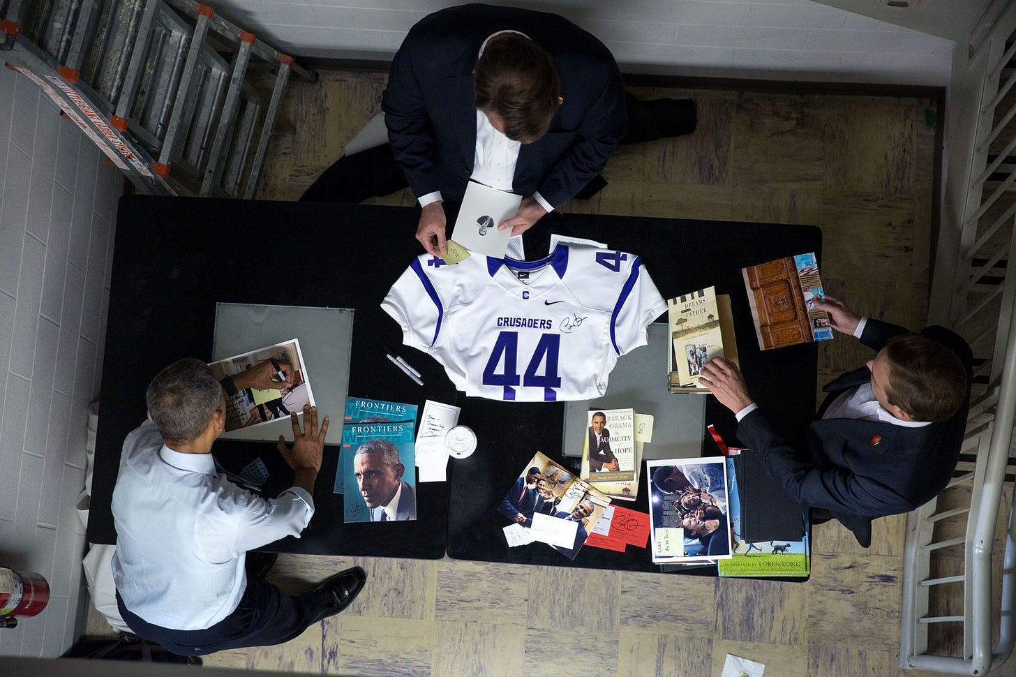 November 1, 2016: An unusual overhead view reveals a 'signing table' backstage in Columbus, Ohio, laden with memorabilia awaiting President Obama's signature after a campaign event for Hillary Clinton. November 1, 2016: An unusual overhead view reveals a 'signing table' backstage in Columbus, Ohio, laden with memorabilia awaiting President Obama's signature after a campaign event for Hillary Clinton.