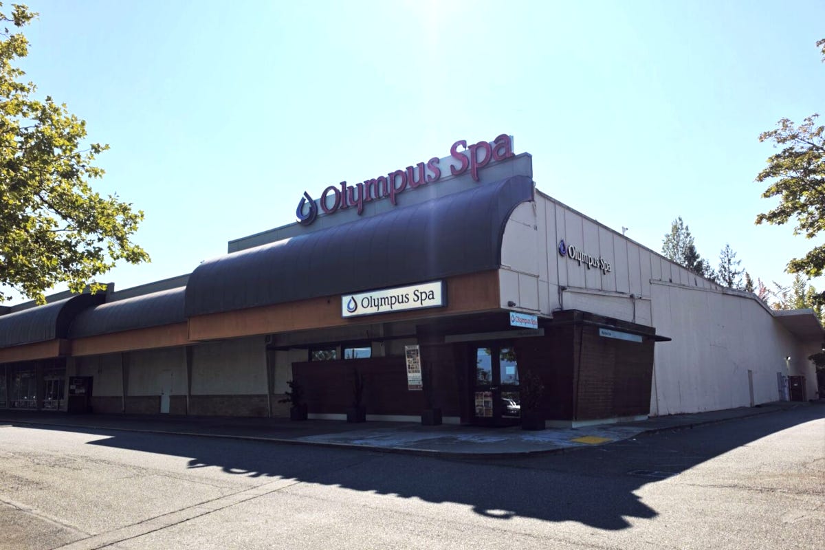 Building with a signs on it indicating it is the Olympus Spa
