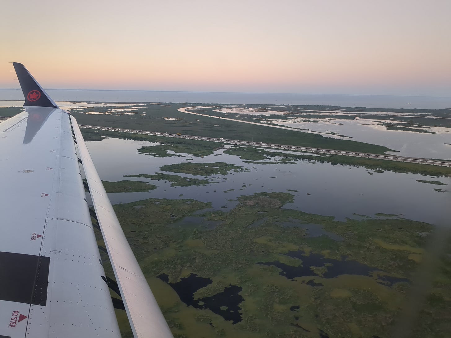 view of airplane wing about to land at MSY.