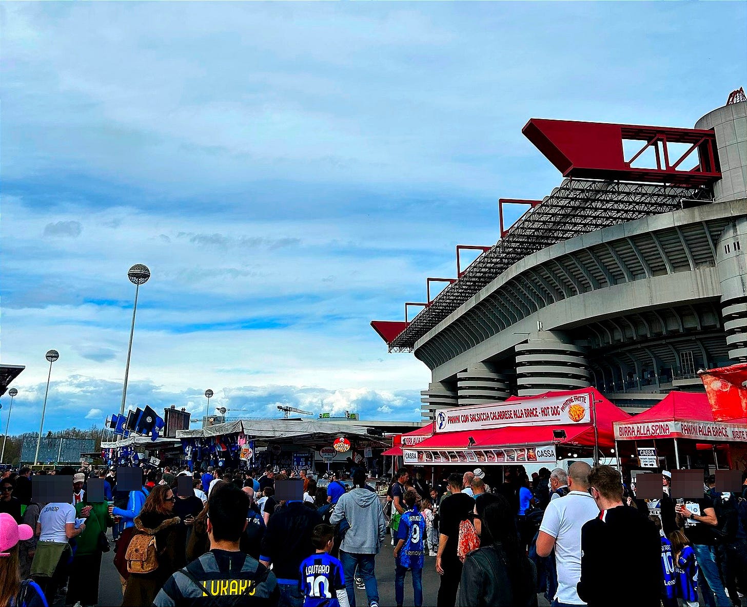 Fans gathering for food, drinks and merch outside the Giuseppe Meazza/San Siro stadium in Milan