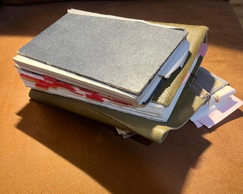 A short stack of books casting a wide shadow.