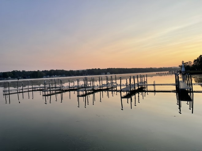 A serene view of Chautauqua Lake at sunrise.