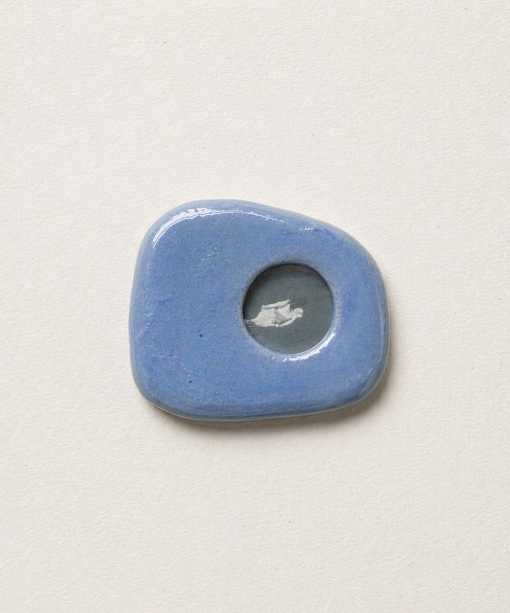 First photo: a small photo frame made of blue ceramics in an organic shape.  Second photo: a notepad with a cozy house as the space to write.