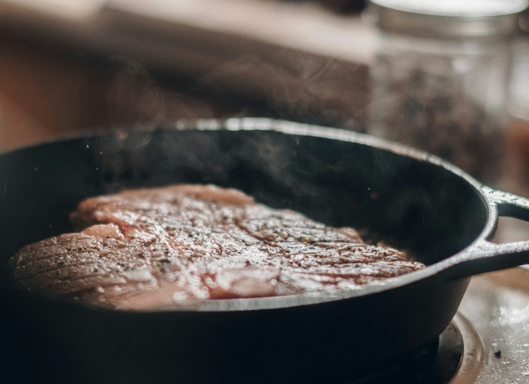 a frying pan with some food cooking on it