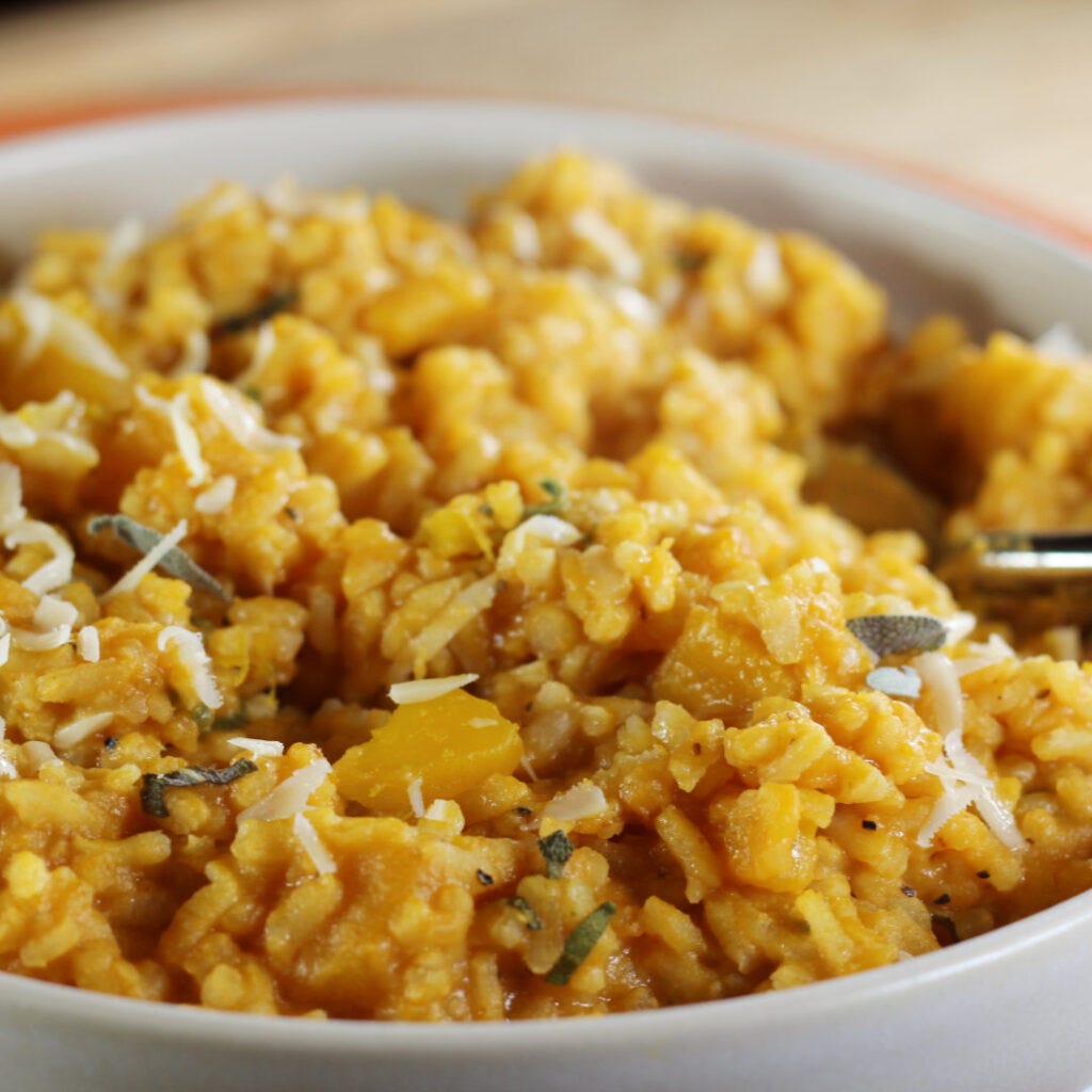 A beautifully captured image of a bowl filled with vibrant and aromatic Creamy, Dreamy Pumpkin Risotto.