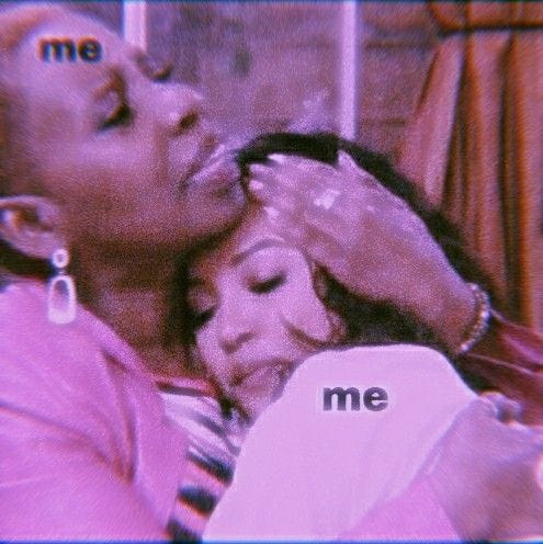 This may contain: the woman is kissing the man's face with her hand on his chest and she has