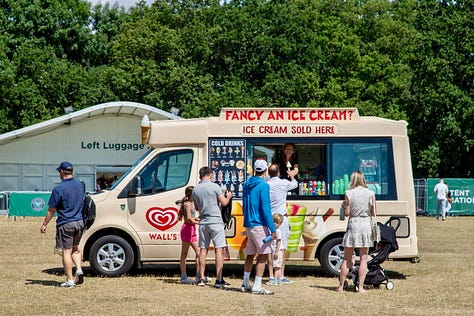 Three scenes from The Queue on a sunny day: a woman shading herself with a yellow umbrella, an ice cream truck with left luggage behind it, and a steward with a Wimbledon umbrella surveying the crowd