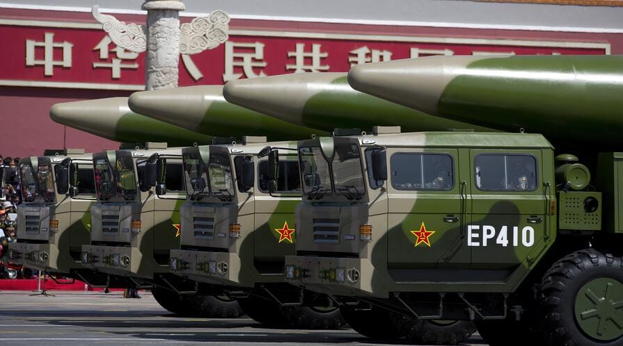 Military vehicles carrying DF-26 ballistic missiles drive through Tiananmen Square during a military parade in Beijing. Military vehicles carrying DF-26 ballistic missiles drive through Tiananmen Square during a military parade in Beijing.