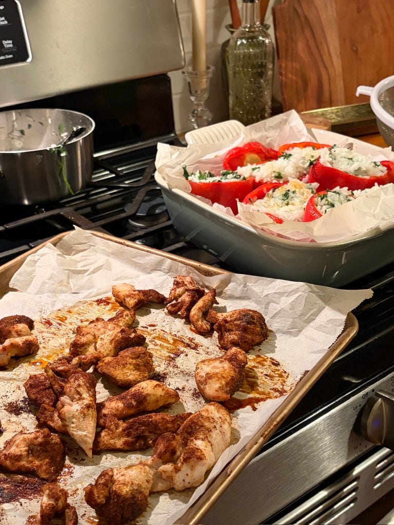 Cilantro-lime rice stuffed peppers with baked chili-seasoned chicken on a sheet pan