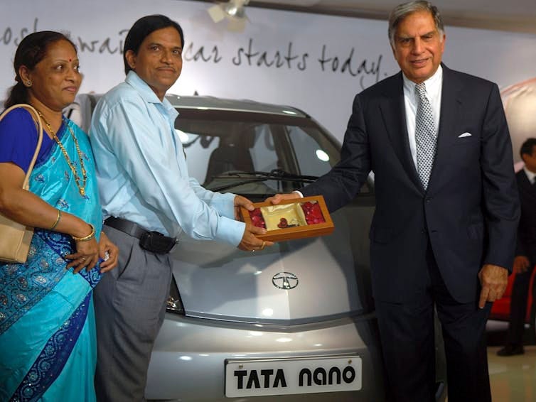 Couple being given car keys.