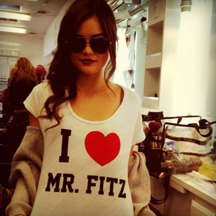 This may contain: a woman wearing sunglasses and a t - shirt with the words i love mr fitz on it