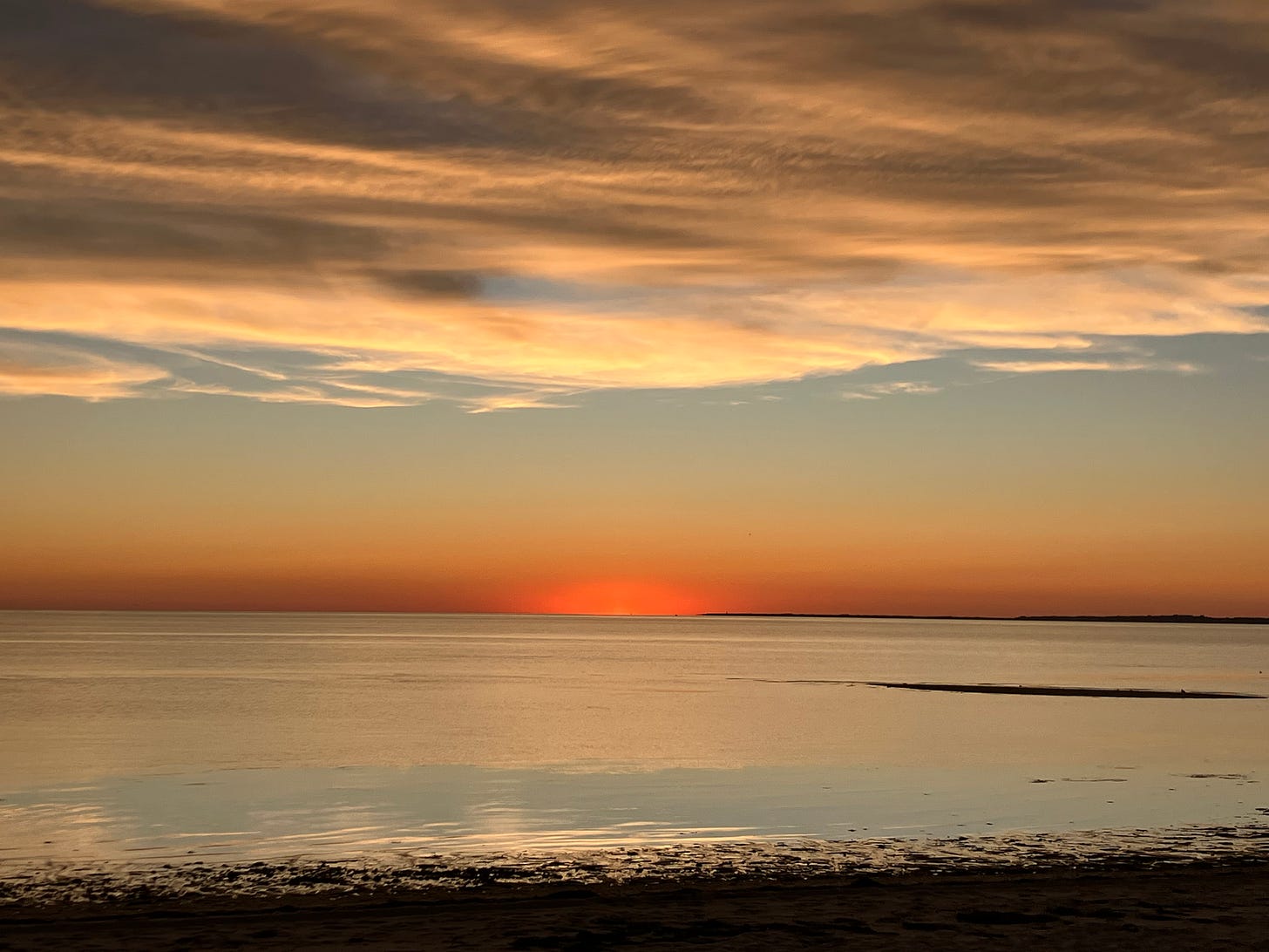 sunset over Cape Cod bay, with orange streaks under clouds
