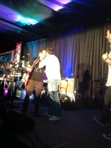 Mark gives Rob a kiss as he leaves the stage