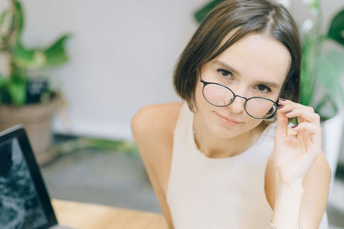 Woman looking over her reading glasses Woman looking over her reading glasses