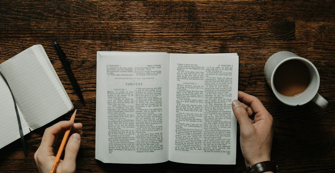 person sitting by the table opening book person sitting by the table opening book