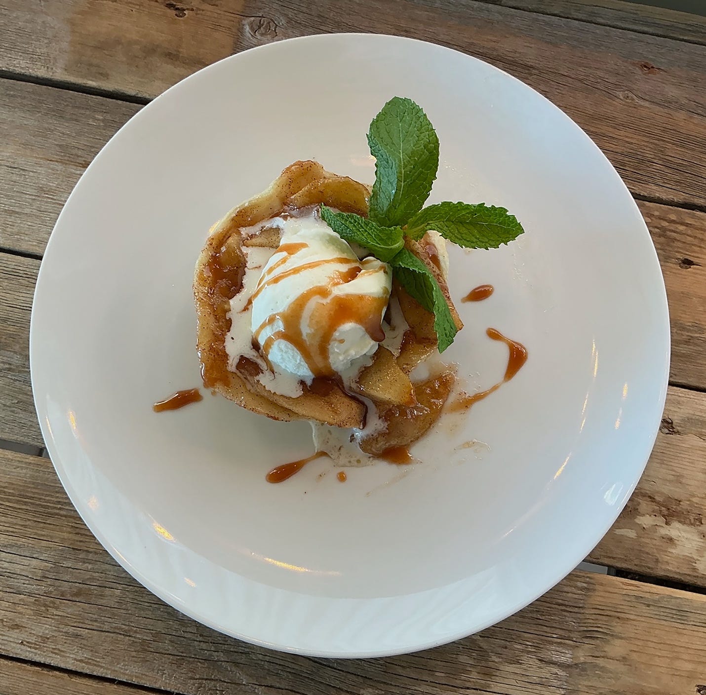 A plate of dessert on a wood table

AI-generated content may be incorrect.