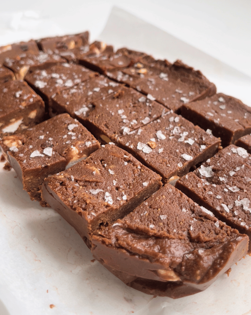 protein fudge sliced into squares on a white parchment paper