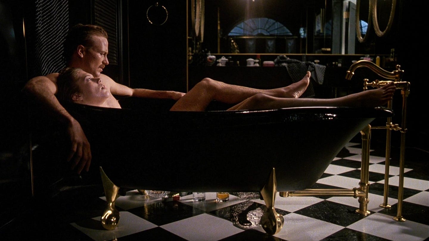 William Hurt and Kathleen Turner recline naked in a black clawfoot bathtub in Body Heat (1981), surrounded by gold fixtures and a checkerboard tile floor, evoking the film’s signature blend of noir seduction and steamy excess. William Hurt and Kathleen Turner recline naked in a black clawfoot bathtub in Body Heat (1981), surrounded by gold fixtures and a checkerboard tile floor, evoking the film’s signature blend of noir seduction and steamy excess.
