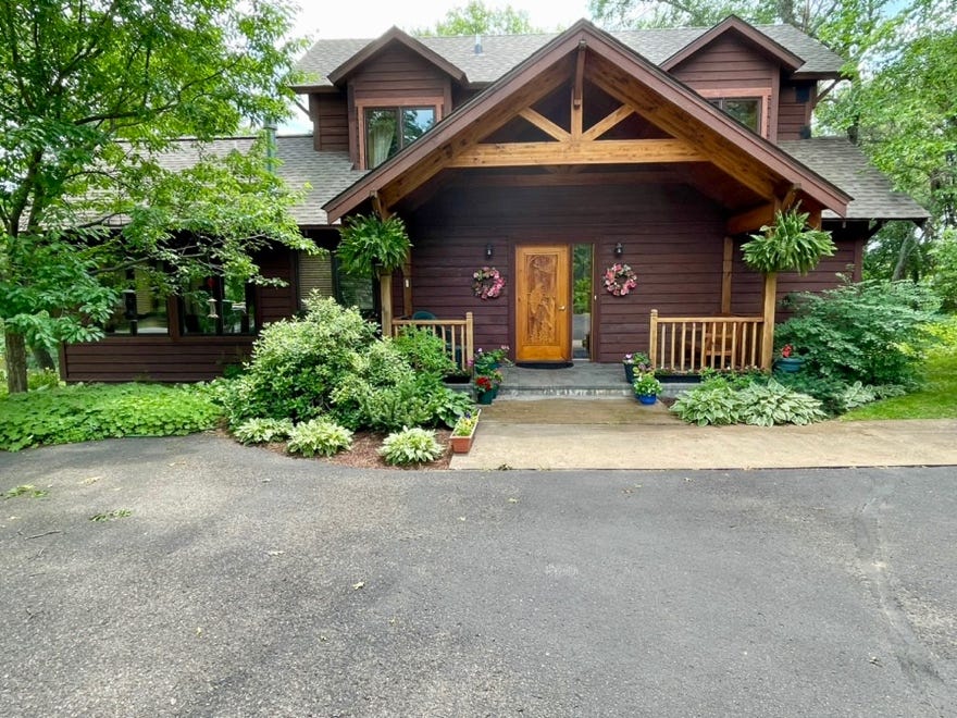 A house with a driveway and trees

Description automatically generated