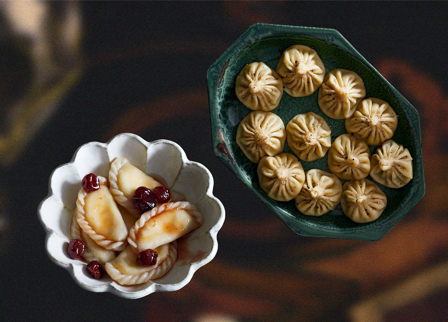 A bowl filled with cherry varenyky next to a platter of khinkali A bowl filled with cherry varenyky next to a platter of khinkali