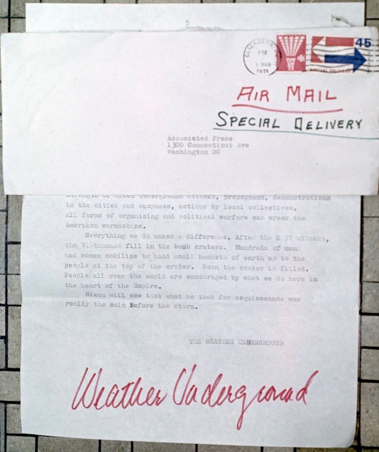 A page from a letter signed in red pen, 'Weather Underground,' claiming to have perpetrated a bombing of the U.S. Capitol building.