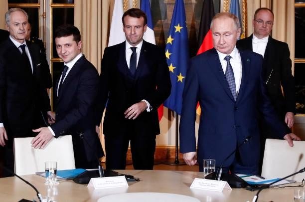 Ukrainian President Volodymyr Zelensky , French President Emmanuel Macron and Russian President Vladimir Putin arrive to attend a meeting on Ukraine...