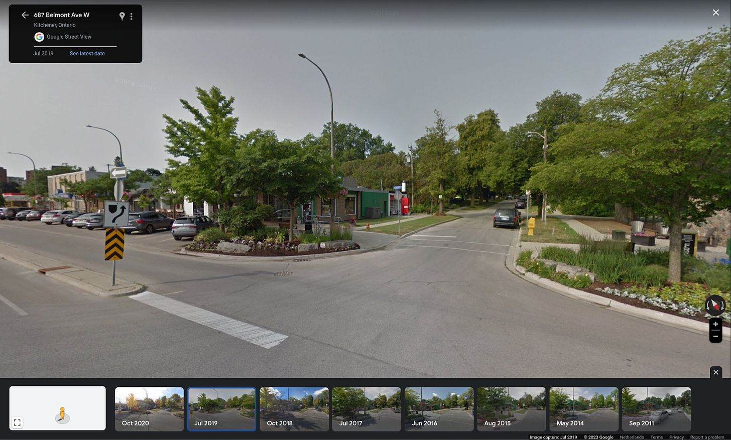 Image shows a main street with an intersecting street. The main street has a median which divides it into a service street and the intersection street intersects both the service street and the main street.