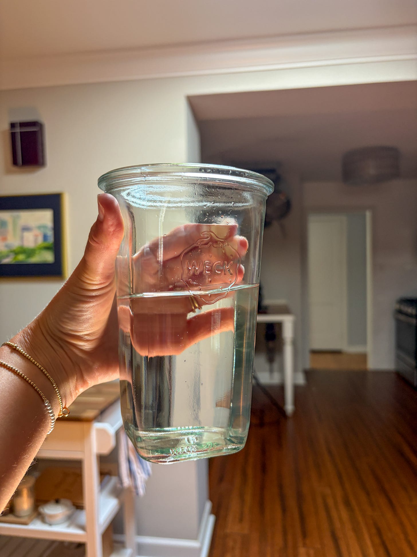 a cup of water without ice in a glass jar