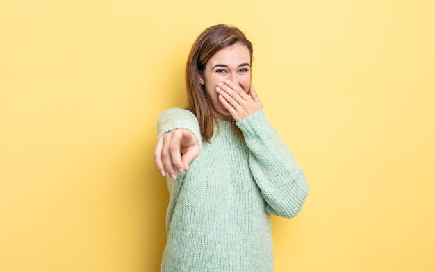 Premium Photo | Young pretty girl laughing at you, pointing to camera and  making fun of or mocking you