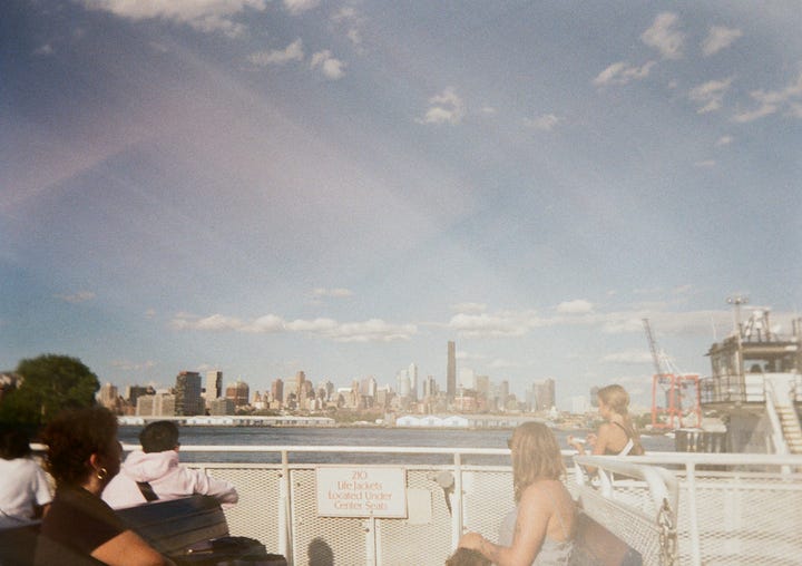 Photo 1: Canoers on the Gowanus Canal, Photo 2: Selfie of the author and friends at the farmer's market, Photo 3: Assortment of flowers on sale at the farmers market, Photo 4: New York skyline taken from a ferry taken in the day, slightly overexposed and hazy