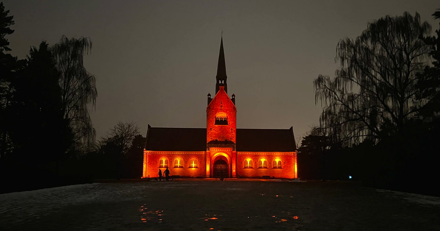 a brightly-lit church against a dark sky